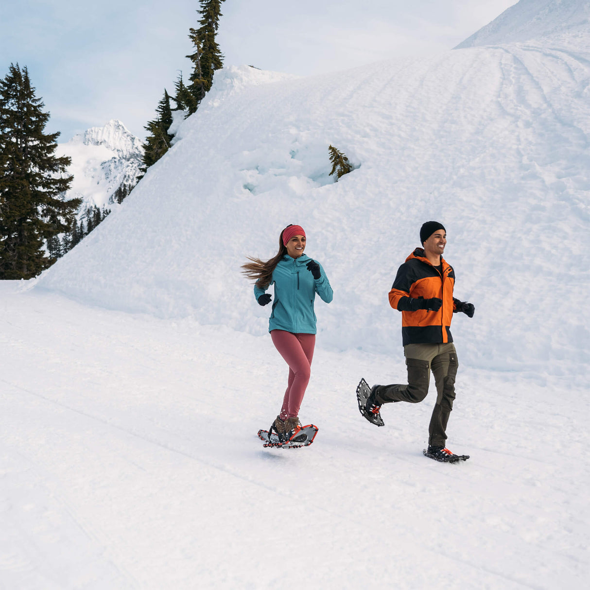 Athlete wearing grey race snowshoes running through snow