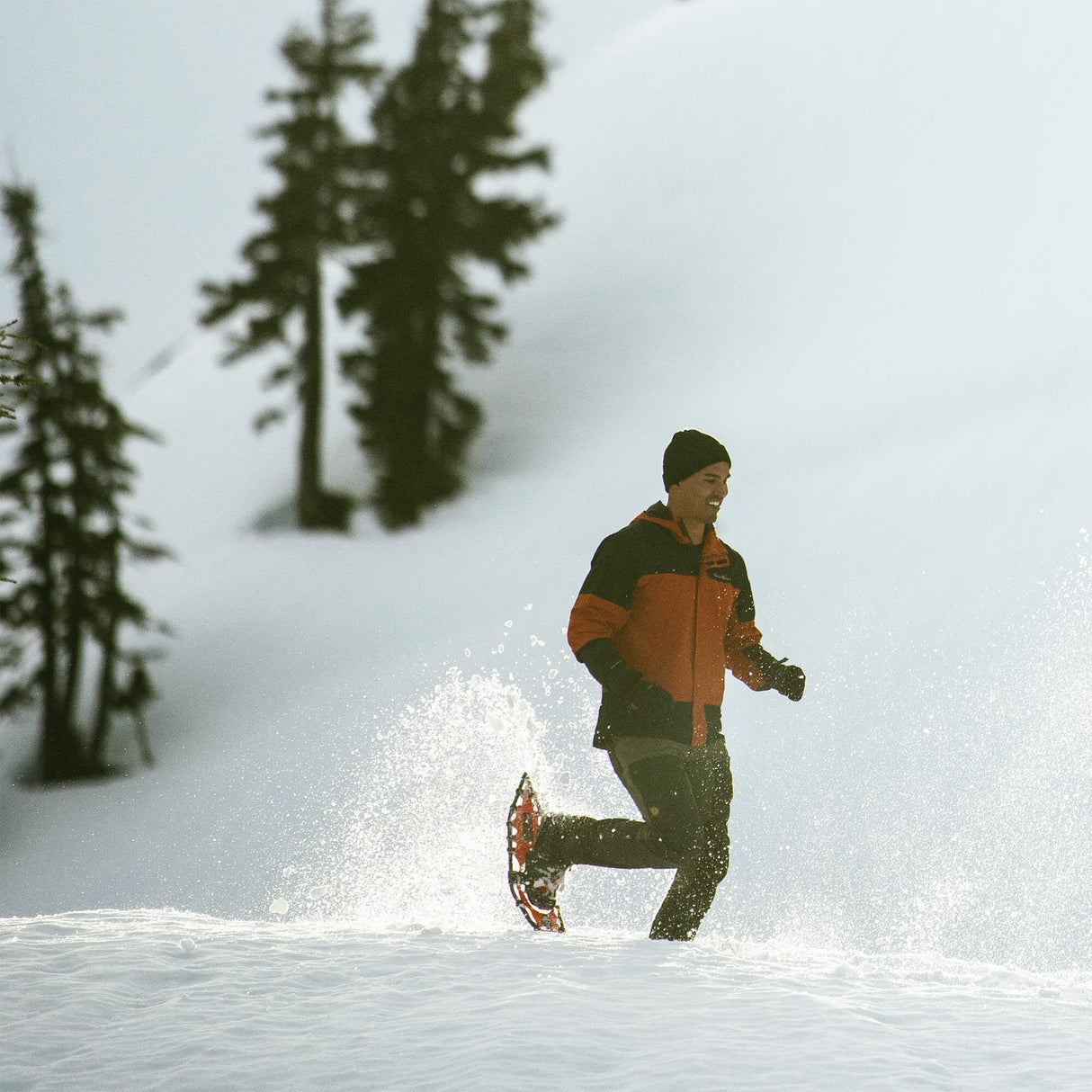 Runner sprinting in snow wearing Race Wave ultralight race snowshoes